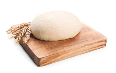 Wooden board with raw dough on white background