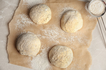 Fototapeta na wymiar Fresh raw dough with poppy seeds and flour on table, top view