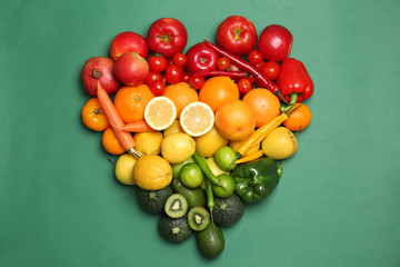 Rainbow composition with ripe fruits and vegetables on color background, top view