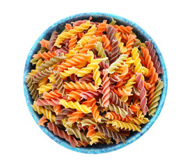 Bowl with uncooked fusilli pasta on white background, top view