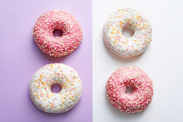 Delicious glazed doughnuts on color background, top view