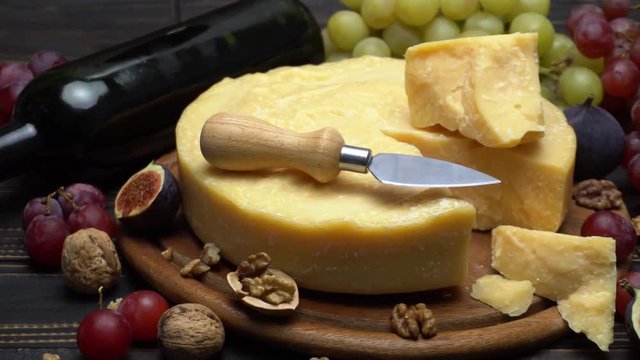 Whole round Head parmesan cheese, wine and grapes