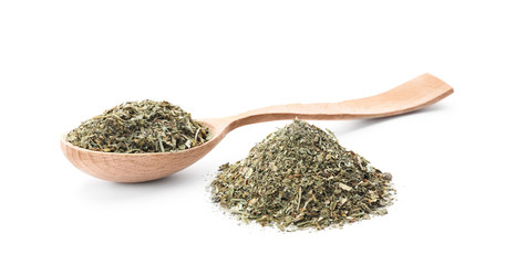 Wooden spoon and dried parsley on white background