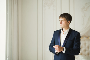 Portrait of happy businessman standing in studio