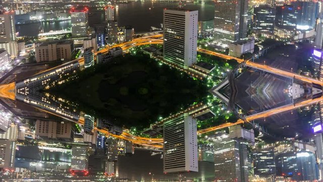 Night Time-Lapse of downtown in Tokyo with trains and reflection