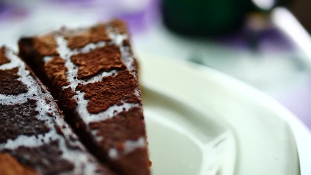 Chocolate cake piece. Sliced tasty chocolate cake on table background
