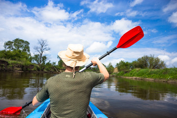 Kayaking on beautiful nature at summer sunny day. Sport people having fun