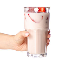 Glass of milkshake strawberry yogurt in hand