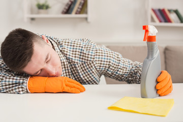 Tired man having rest after cleaning home