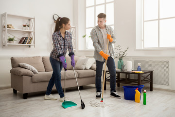 Couple cleaning at home together