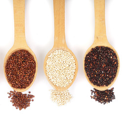 Black red white quinoa seeds in wooden spoon isolated on white background. Top view
