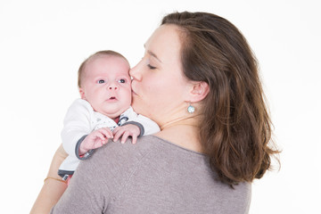 loving family mother kiss newborn baby girl child in shoulders