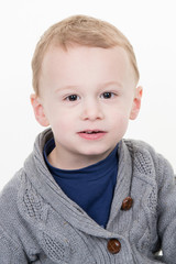 cheerful young kid boy child wer grey pullover
