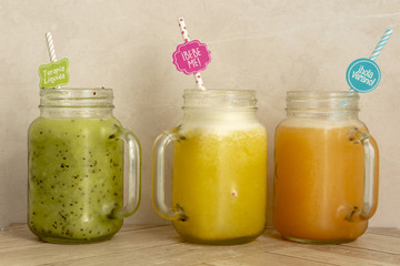 Organic fruit smoothies on wooden surface