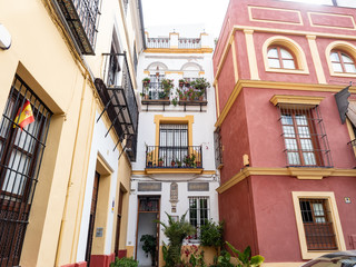 Typical street in Seville with colourful houses. Andalusia, Spain.