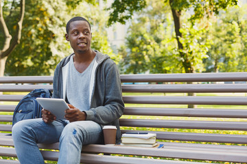 Fototapeta premium Concentrated man working on his tablet outdoors