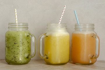 Organic fruit smoothies on wooden surface