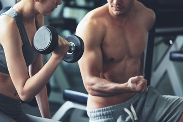 Fototapeta na wymiar Fitness man and asia woman doing exercise in gym
