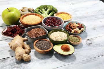 superfood concept on white table with avocado, goji and nuts and seeds.