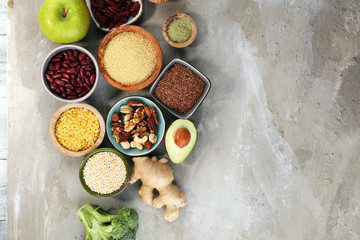superfood concept on stone table with avocado, goji and nuts and seeds.