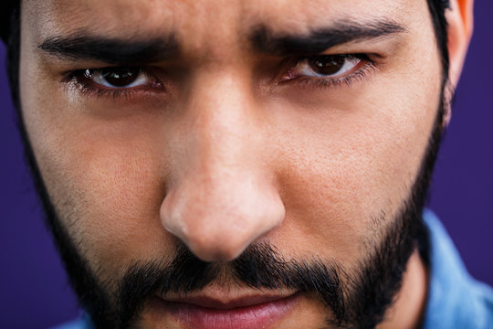 Close up portrait of eastern arabian man on purple background
