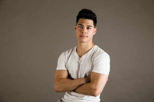 Young man sitting on chair in studio