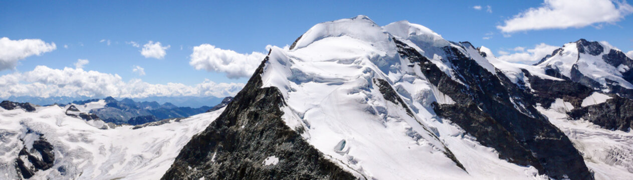 panoramic view of the Val Poschiavo and Piz Palu in the Bernina mountains as seen from the summit of Piz Cambrena
