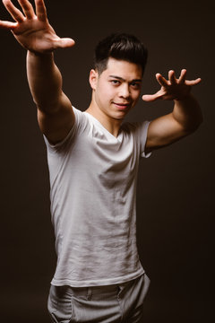 Smiling man with arms outstretching forward