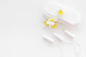 Woman hygiene protection. Cotton tampons and sanitary pads on white background top view copy space