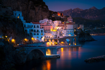 Night view of Amalfi cityscape on coast line of mediterranean sea, Italy