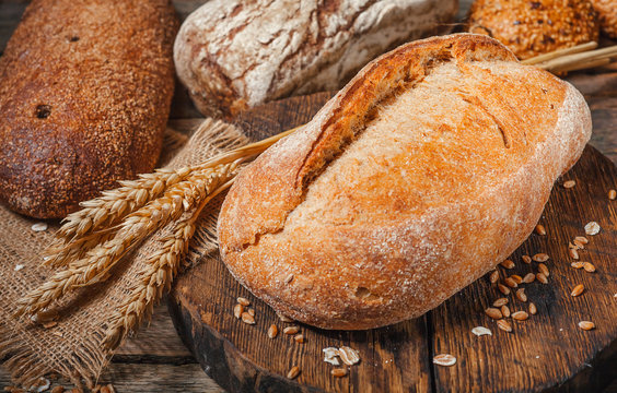 bread in rustic style retro background.Fresh traditional bread on wooden ground with flour in a sack.