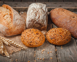bread in rustic style retro background.Fresh traditional bread on wooden ground with flour in a sack.