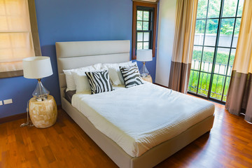 Obraz premium Interior of modern bedroom with Parquet floors on a sunny day,Classic bedroom style