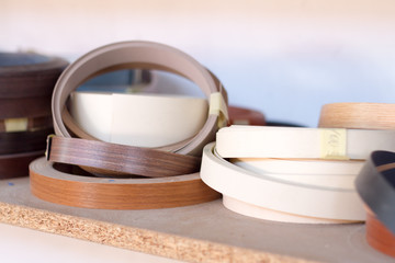 Furniture accessories. Multicolored bobbins of PVC edge and melanin for the manufacture of...