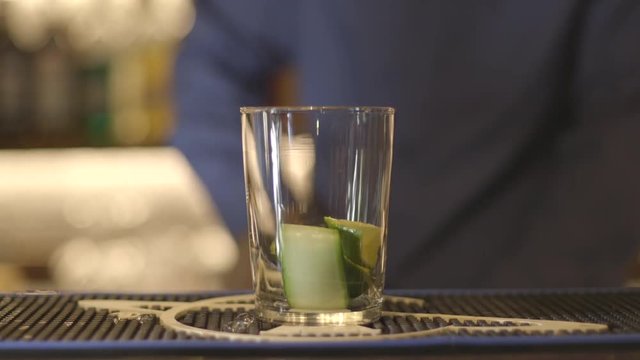 Close up, bartender uses cocktail muddler