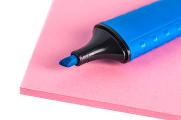 Blue marker and paper on a white background