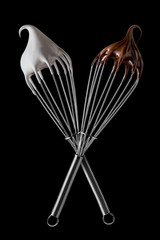 Whisk with meringue cream and melted chocolate Isolated on white