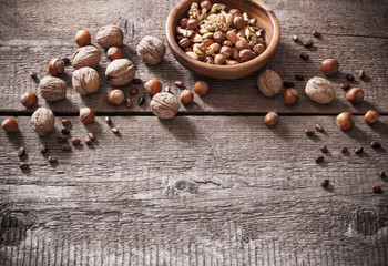 Mixed nuts on old wooden background