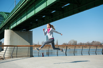 Fototapeta na wymiar Women running on bridge