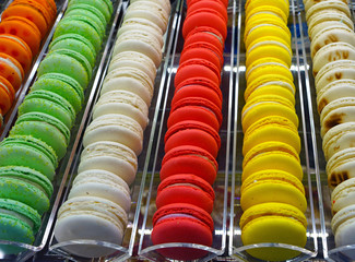 Rows of colorful macaron cookies in a pastry shop