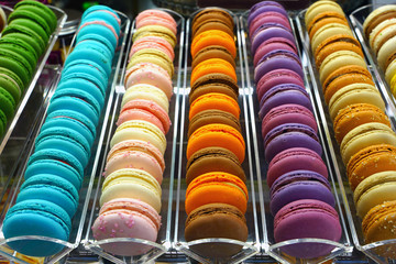 Rows of colorful macaron cookies in a pastry shop
