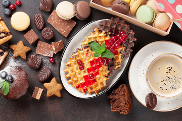 Coffee, sweets and waffles with berries
