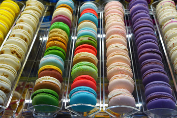 Rows of colorful macaron cookies in a pastry shop