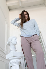 Smiling young woman in a gray sweatshirt. Mock-up.