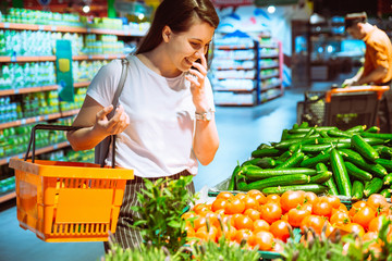 woman buying vegetables in grocery store. shopping concept