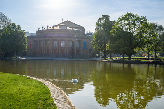 Stuttgart State Theatre Opera building and fountain in Eckensee lake, Germany