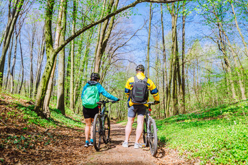 couple stand in forest with bicycles. sport life concept