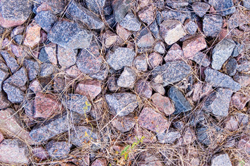 Small stones lying on the ground. Stone background texture