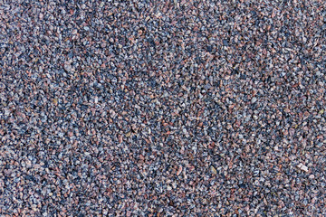 Tiny stones background texture. Natural grey gravel on the ground