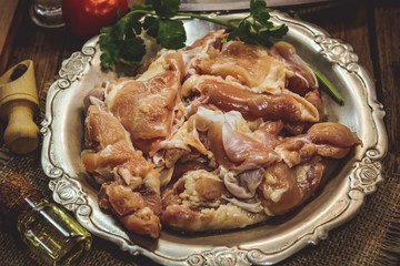 cooking raw chicken with vegetables. on a wooden background.